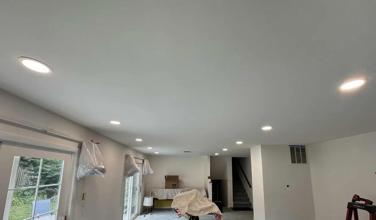 Recessed can lighting installed across a living room ceiling