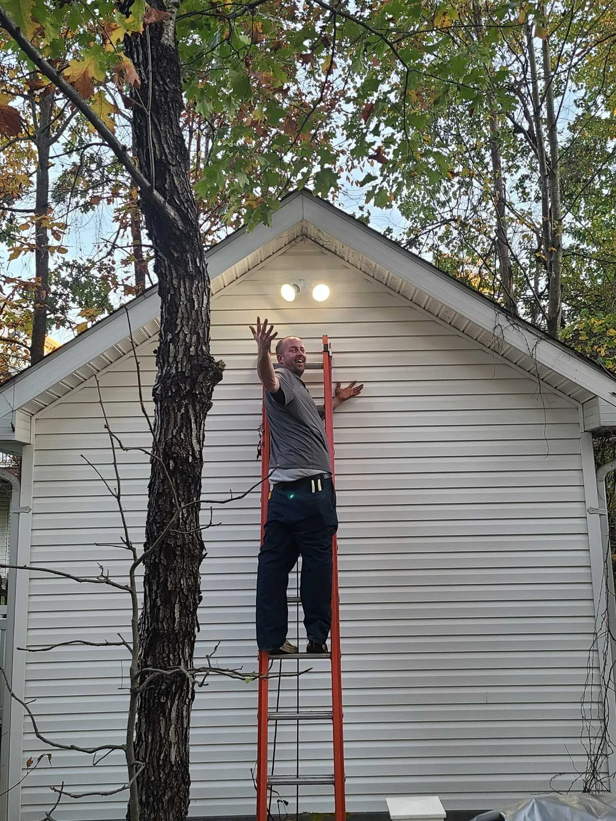 Exterior flood lights installed on a house gable