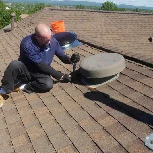 Second roof attic fan installation in progress
