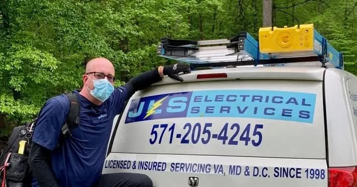Joey Sauls beside the JLS Electrical Services van